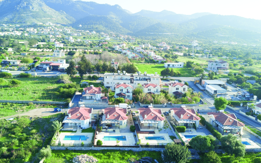 Doğanın merkezindeki Karşıyaka Villaları Kıbrıs konut projesinin modern görünümü.